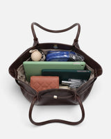 Lifestyle shot of the woven tote bag carried on the shoulder