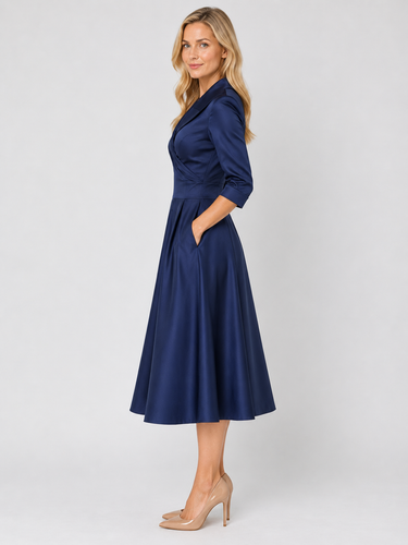 Side view showing the pleated A-line skirt and three-quarter sleeve length
