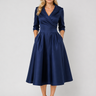 Front view of a wrap front midi dress with pleated A-line skirt and notched lapel collar