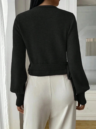 Front view of the wrap sweater in black